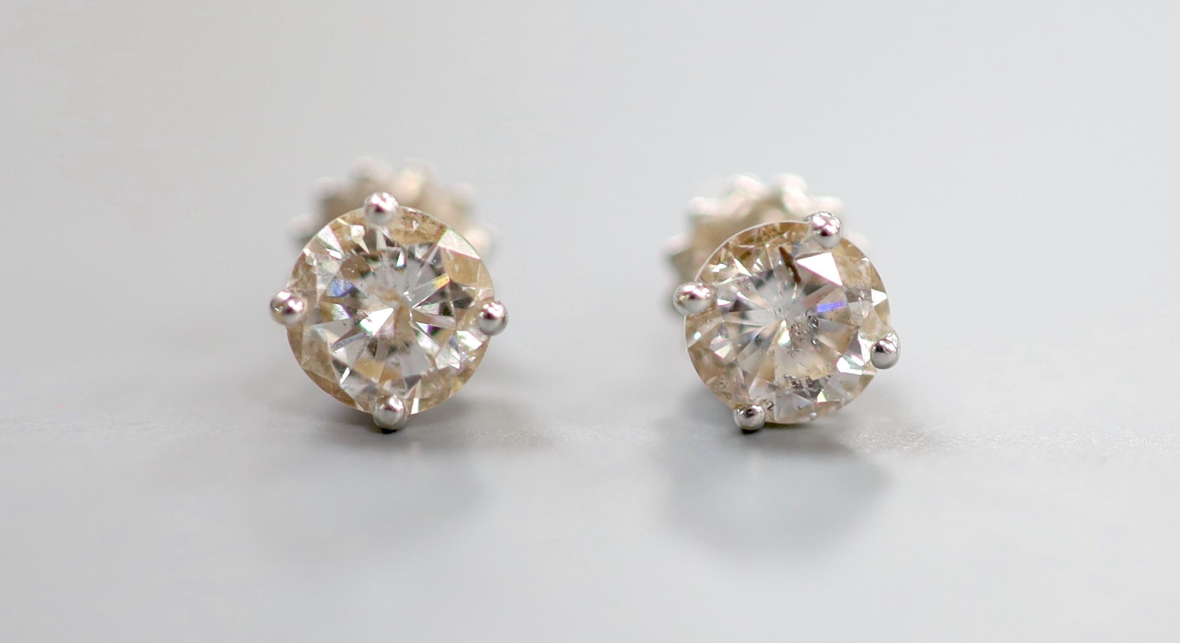 A pair of 18ct white metal and solitaire diamond ear studs, with a total diamond weight of approximately 1.50ct, gross weight 2 grams